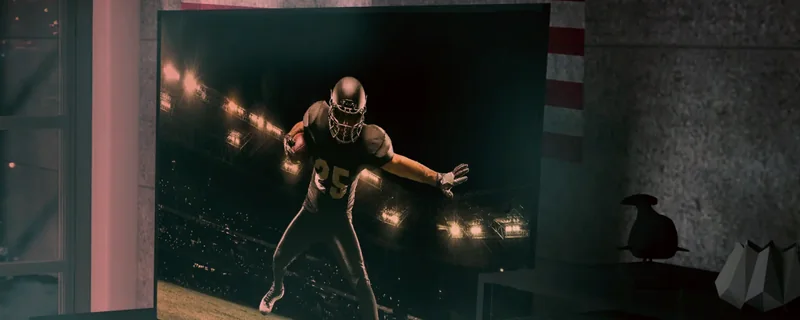 Living room TV showing a night NFL game, with a US flag on the wall